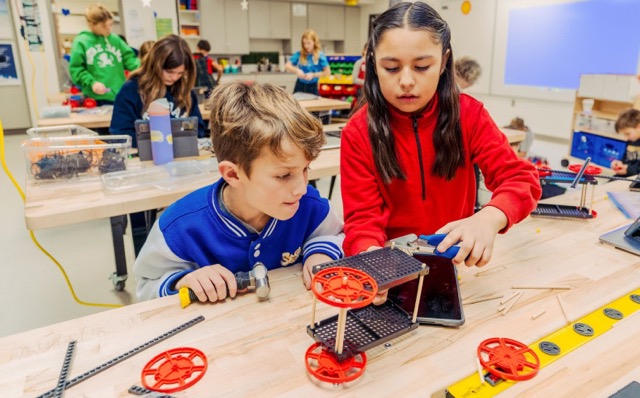 A picture of two kids exploring the maker space area.