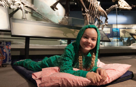 A picture of a kid on a bed in the community science museum
